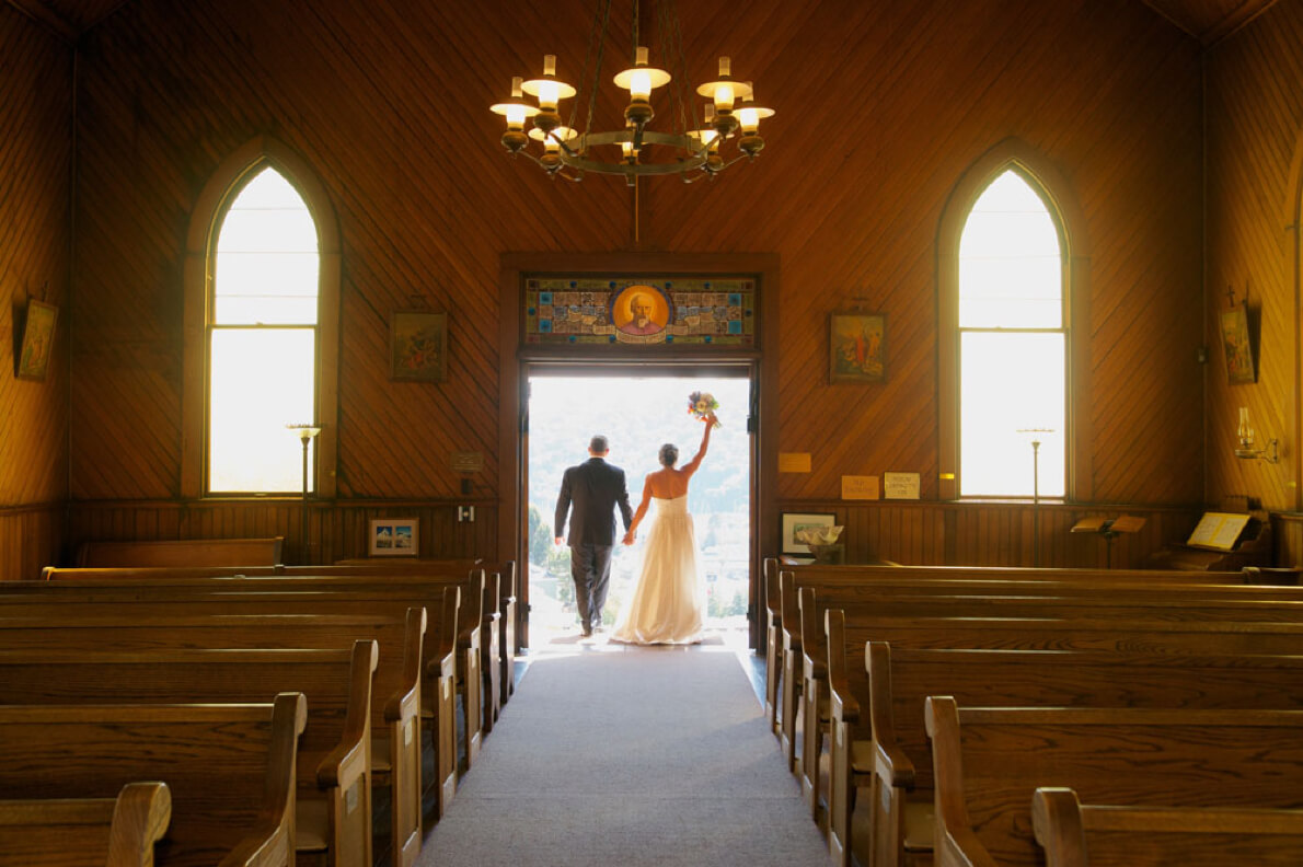 Wedding couple is photographed leaving the church