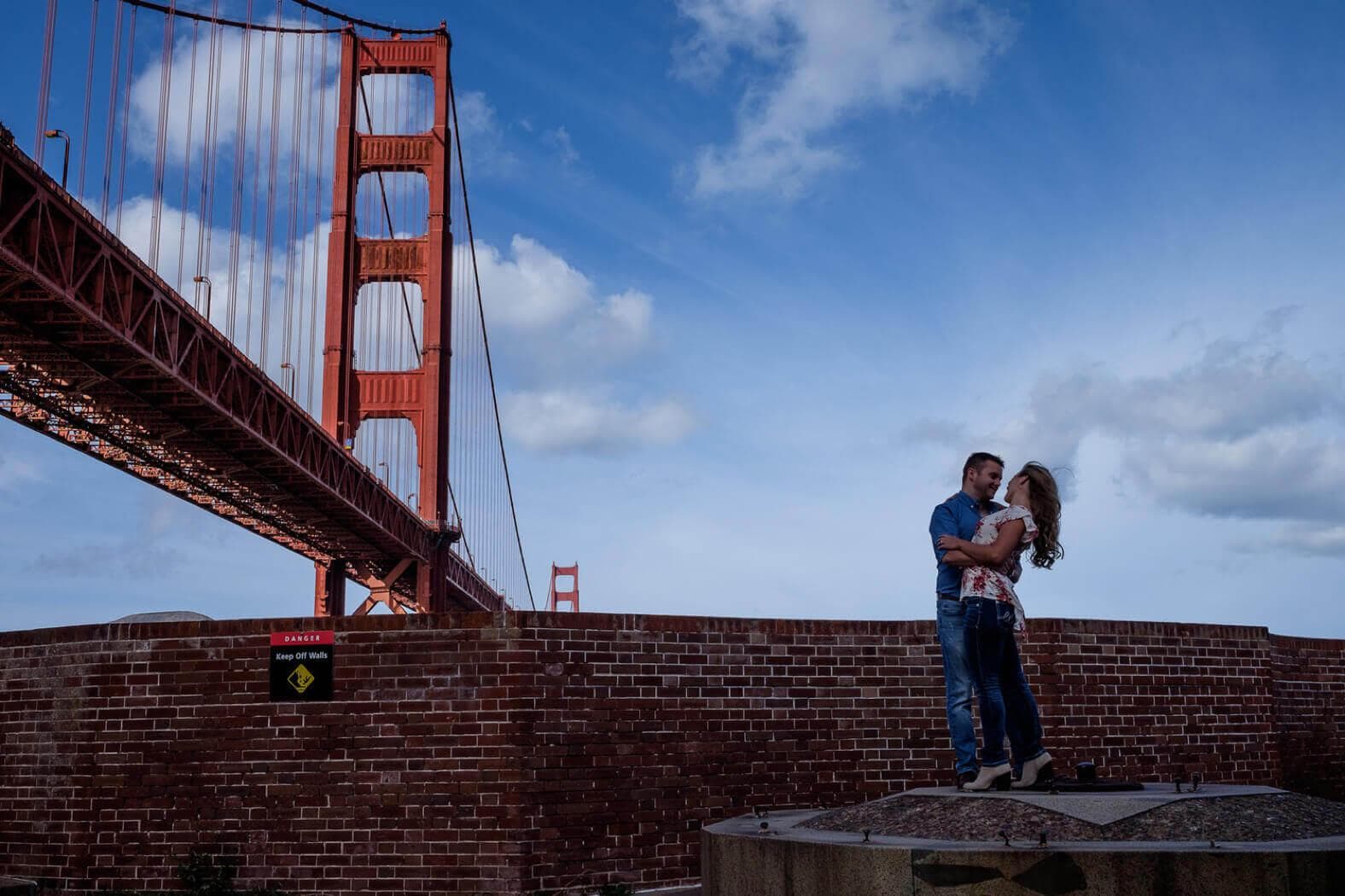 A couple gets engaged under the Golden Gate Bridge