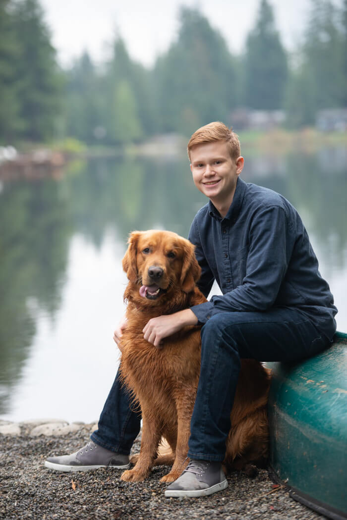 Young man poses with dog