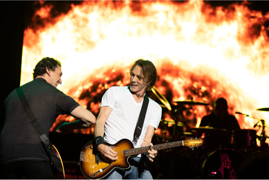 Man playing electric guitar at charity event